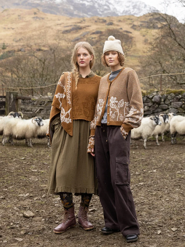 Two women standing next to each other, wearing layers of clothing in earth tones from Gudrun Sjödén.