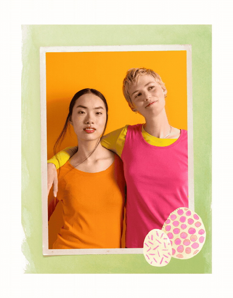 Two women holding one another wearing clothes from Gudrun Sjödén. The picture has a green frame with two watercolour painted Easter eggs.