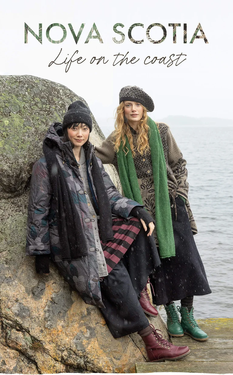 Two women wearing layers of clothing and accessories from Gudrun Sjödén’s 2025 winter collection. 