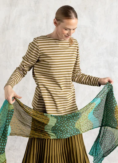 A woman wearing a striped jersey top from Gudrun Sjödén.