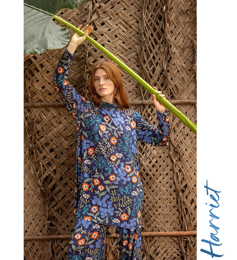 A woman wearing a floral tunic and trousers from Gudrun Sjödén.