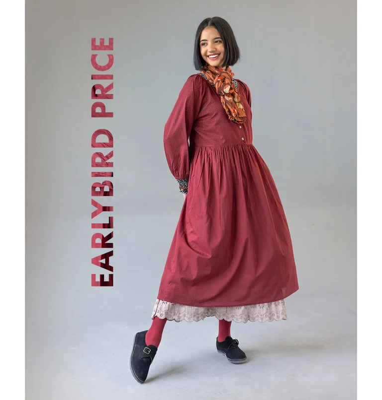 A woman posing in a red woven dress from Gudrun Sjödén.