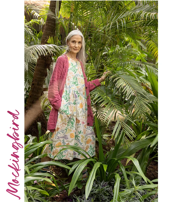 A woman wearing a patterned dress from Gudrun Sjödén.