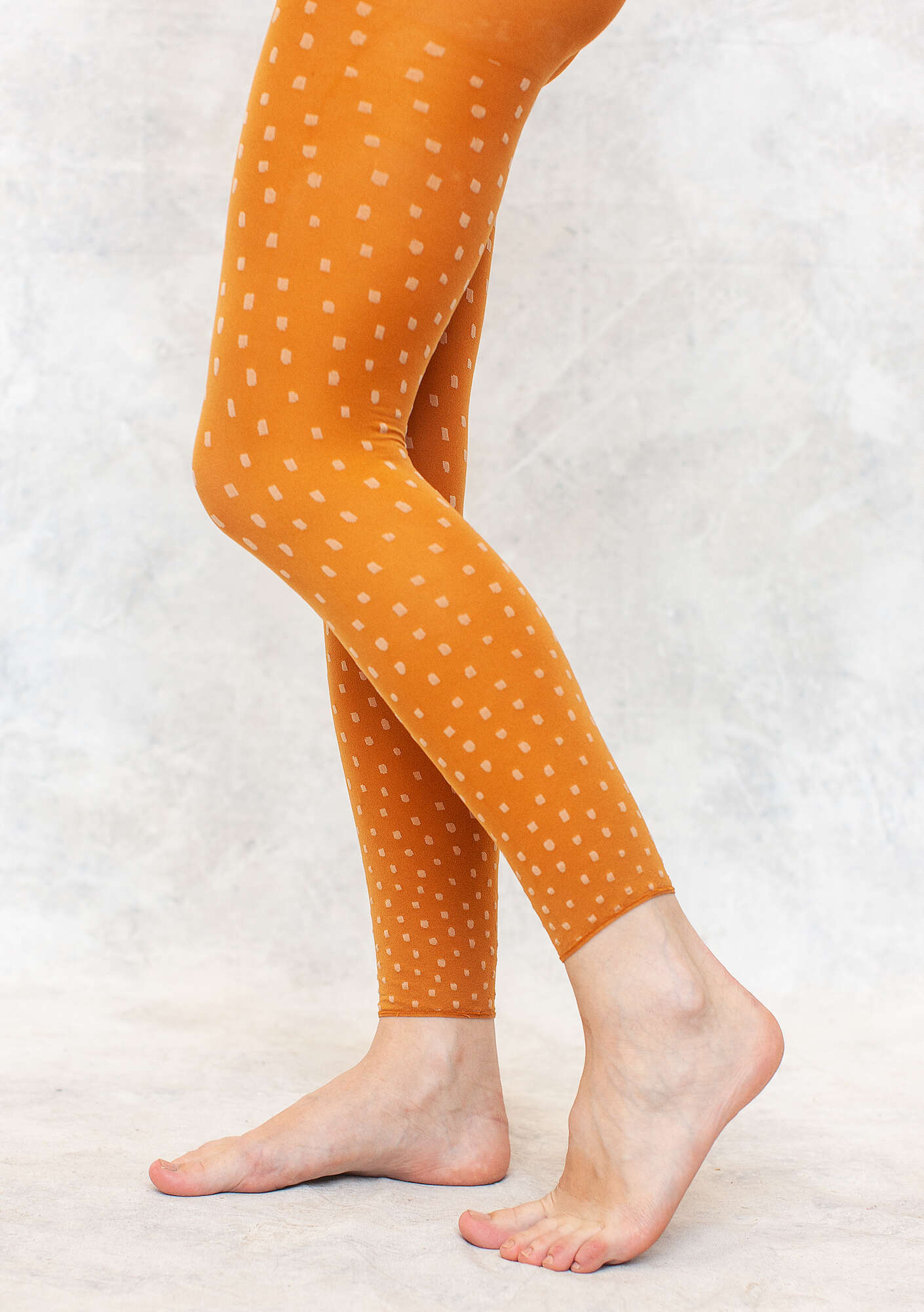 “Tilde” jacquard-patterned leggings in recycled nylon burnt sienna