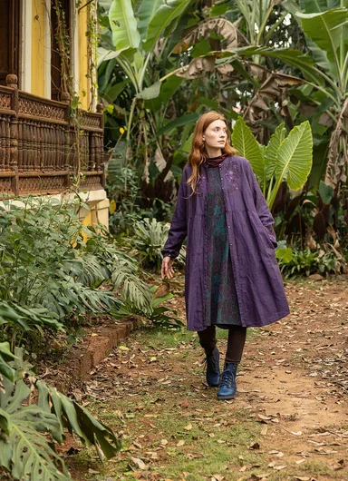 A woman wearing a patterned cardigan from Gudrun Sjödén. 