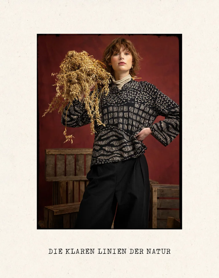 A woman wearing a top with a black and white pattern from Gudrun Sjödén.