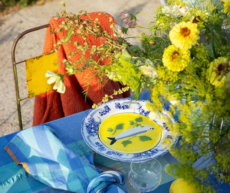 A table with textiles from the Gudrun Sjödén Home collection.