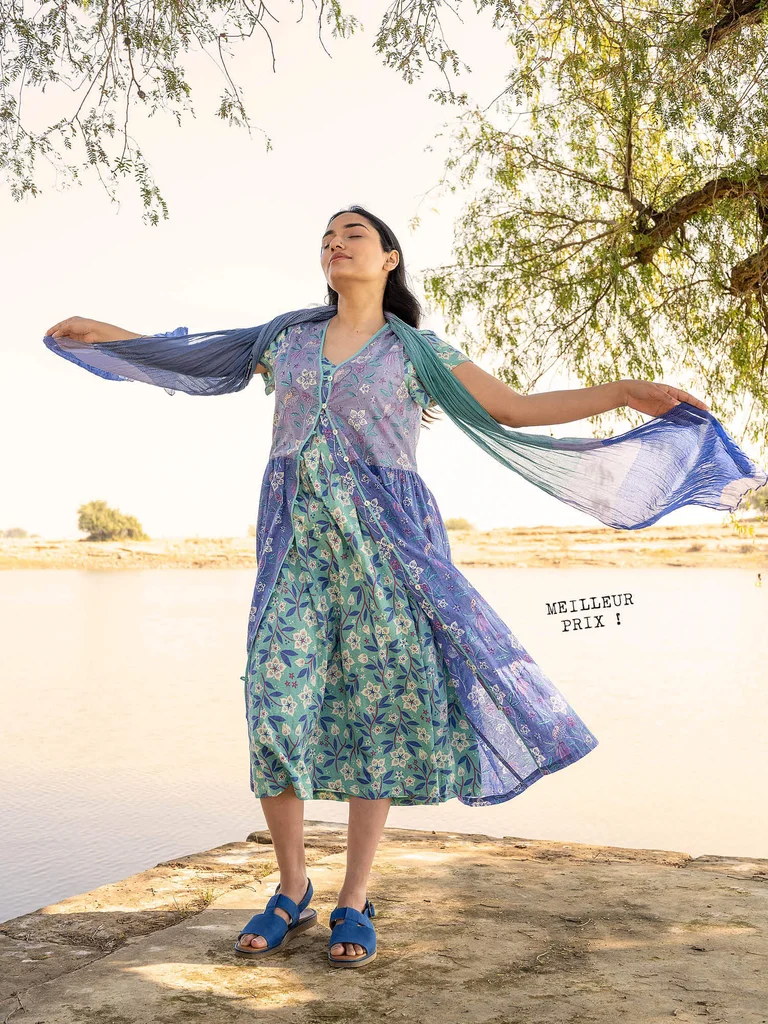 A woman wearing two floral dresses from Gudrun Sjödén.