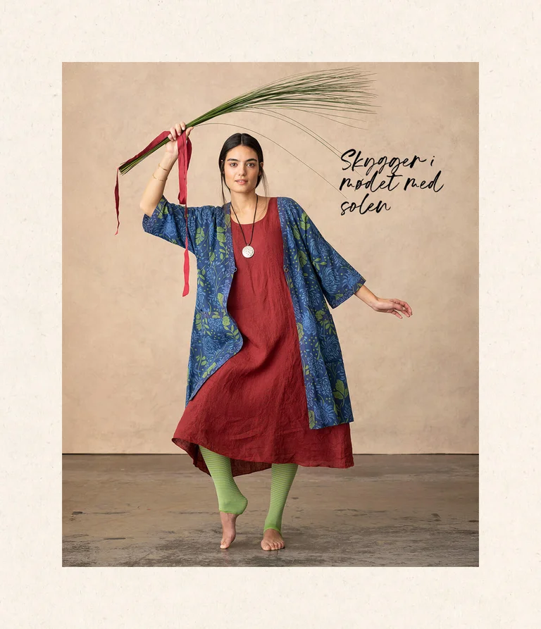 A woman wearing a dress and tunic from Gudrun Sjödén.  