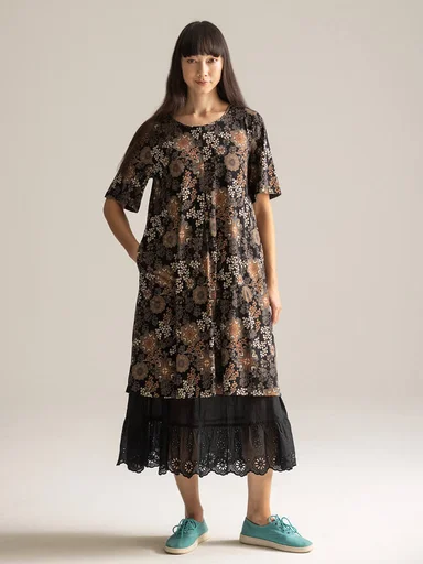 A woman wearing a patterned dress from Gudrun Sjödén.