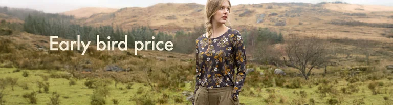 A woman wearing a long-sleeved floral top standing in a landscape with the text "Early bird price".