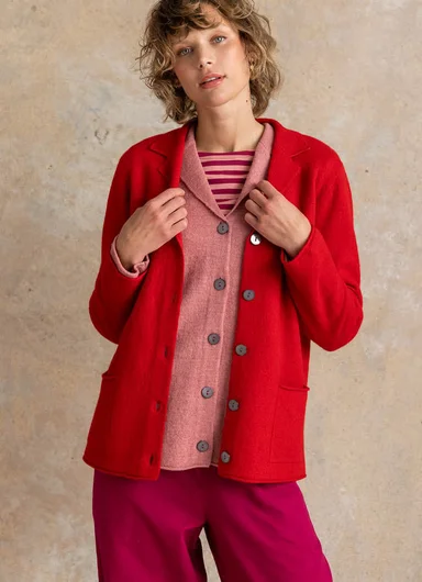 A woman wearing a dotted, knitted cardigan from Gudrun Sjödén.