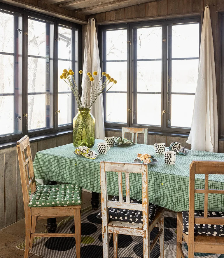 A table laid with home textiles from Gudrun Sjödén’s Home collection. 