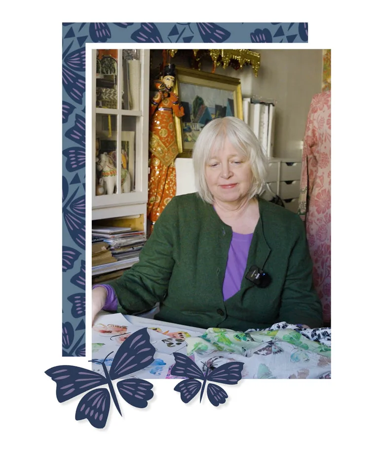 Gudrun Sjödén’s designer Pia is sitting at a desk with drawings and fabrics from her design for the 2026 May collection.