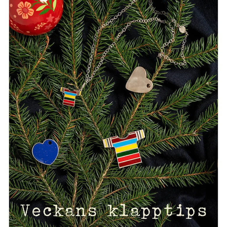 A pile of terry towels of varying sizes from Gudrun Sjödén, tied together with a gift ribbon.