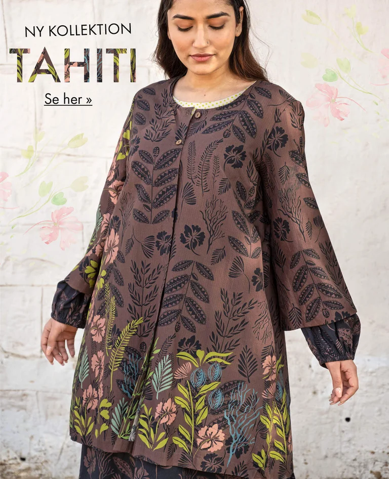 A woman wearing a patterned tunic from Gudrun Sjödén. 