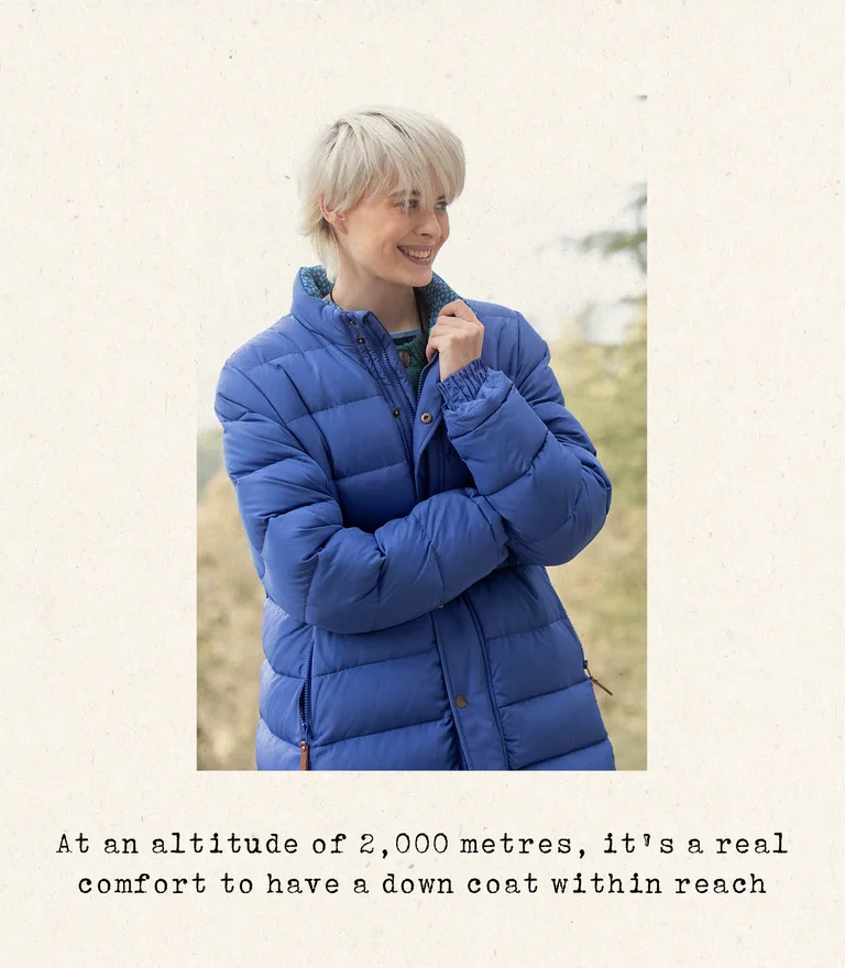 A woman wearing a blue down coat from Gudrun Sjödén.