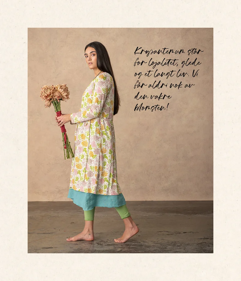 A woman wearing a floral-patterned dress from Gudrun Sjödén.