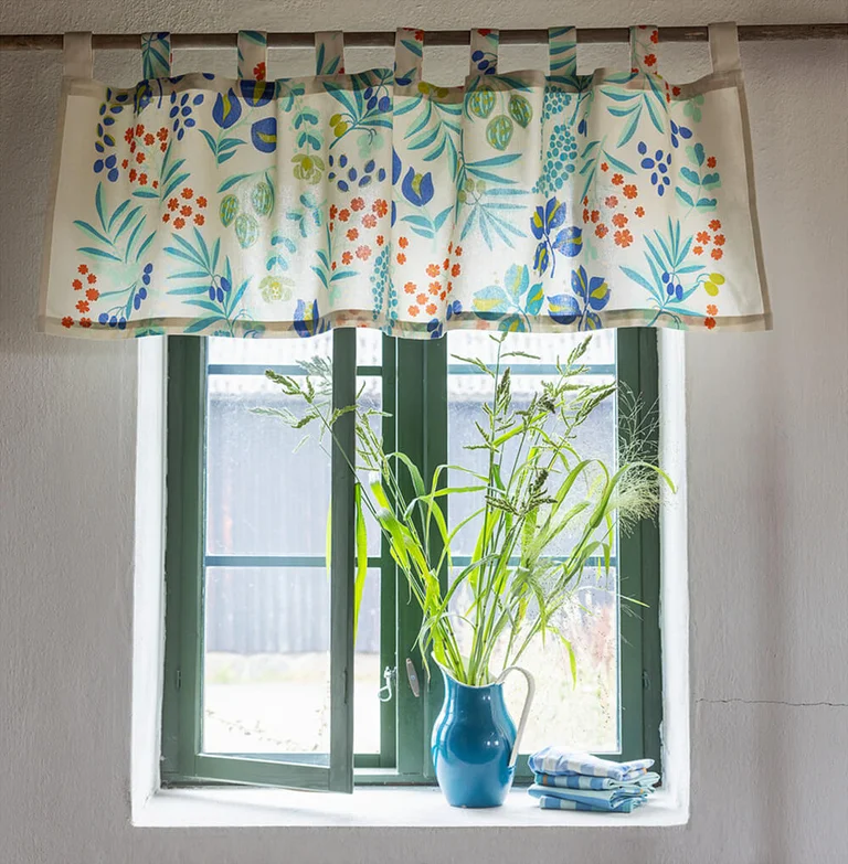 A window with a patterned valance from Gudrun Sjödén. 