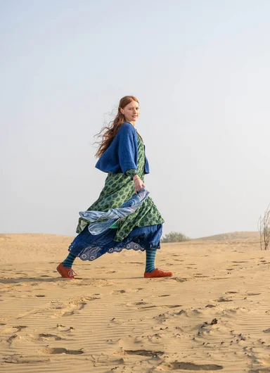 A woman wearing a patterned dress from Gudrun Sjödén. 