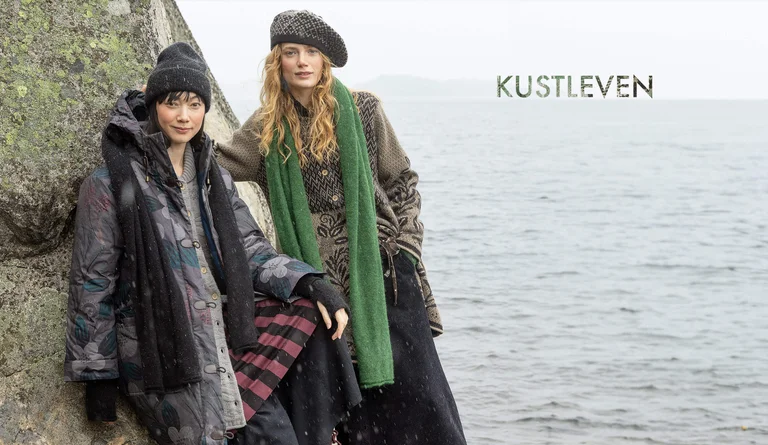 Two women wearing layers of clothing and accessories from Gudrun Sjödén’s 2025 winter collection. 