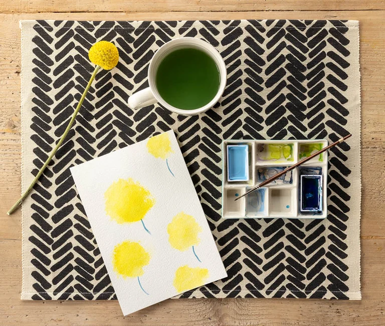 A placemat, mug and palette from Gudrun Sjödén’s Home collection.