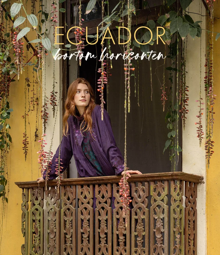 A woman wearing a patterned cardigan from Gudrun Sjödén. 