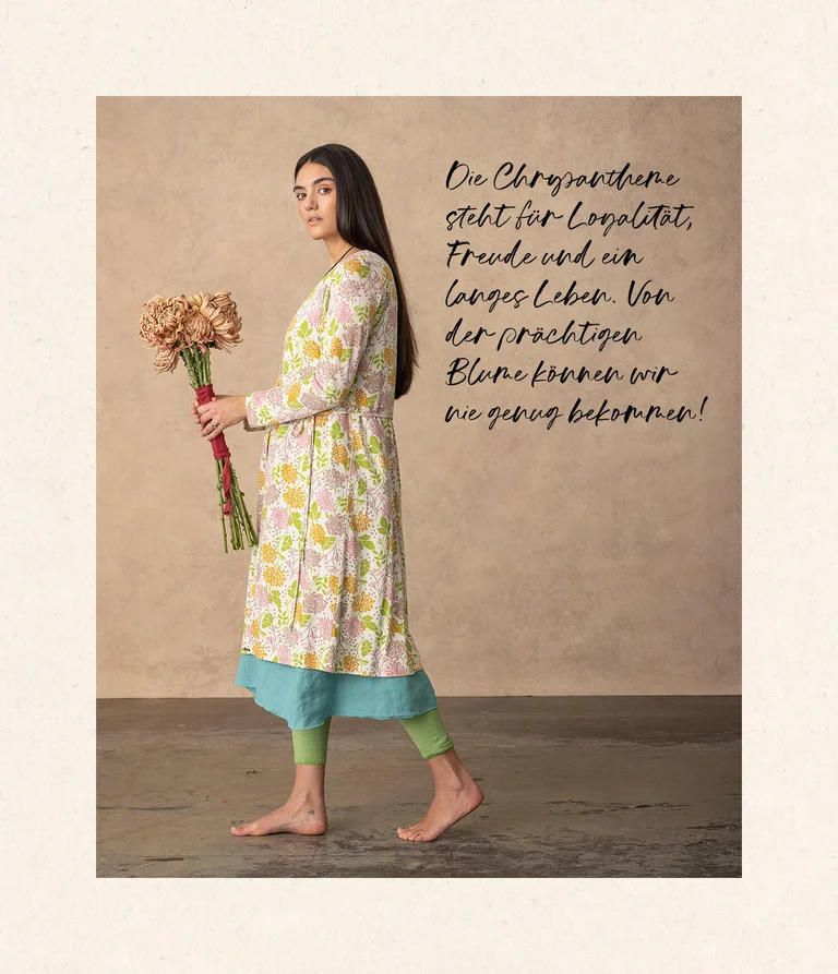 A woman wearing a floral-patterned dress from Gudrun Sjödén.