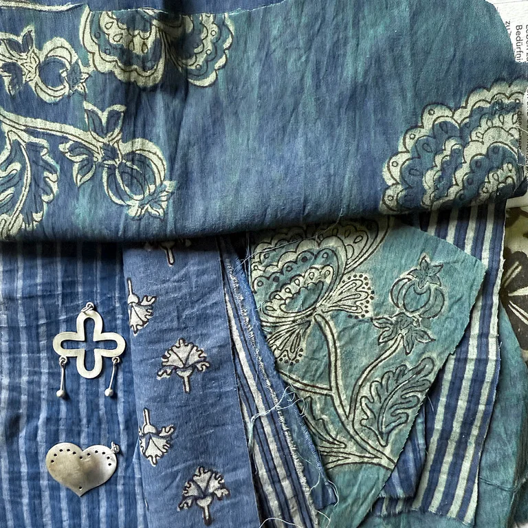 A close-up of block-printed items of clothing in shades of blue from Gudrun Sjödén.