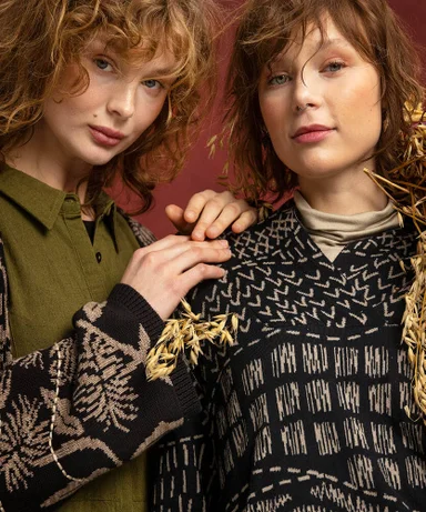 A close-up of two women wearing clothes from Gudrun Sjödén.