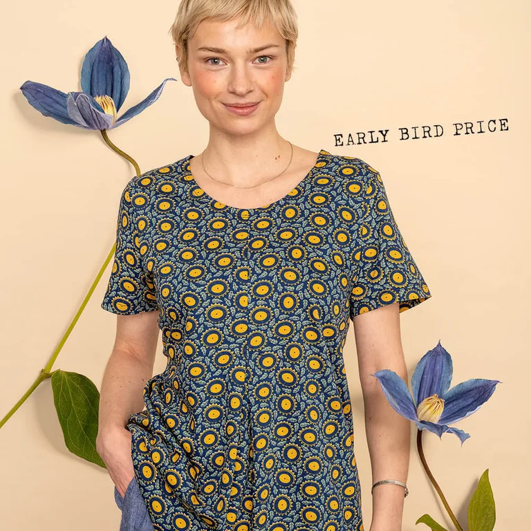 A woman wearing a floral top from Gudrun Sjödén. 