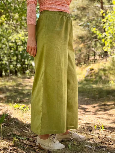 A woman wearing green pants from Gudrun Sjödén.