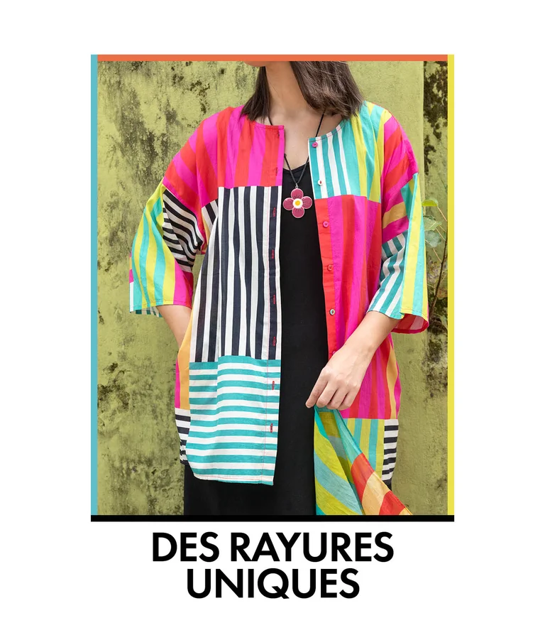 A woman wearing a colorful striped blouse from Gudrun Sjödén.