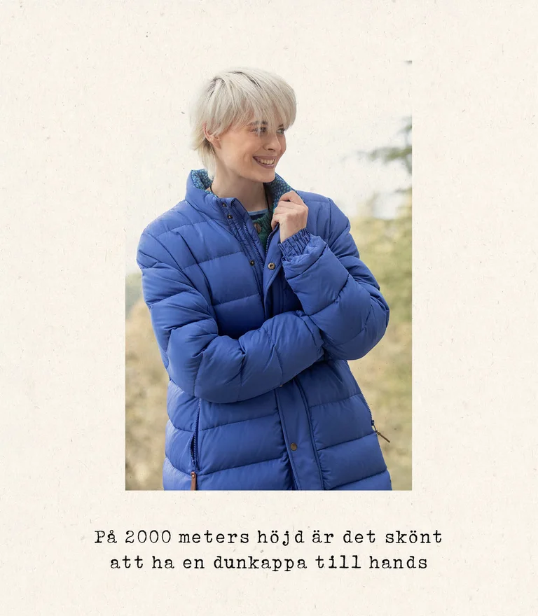 A woman wearing a blue down coat from Gudrun Sjödén.