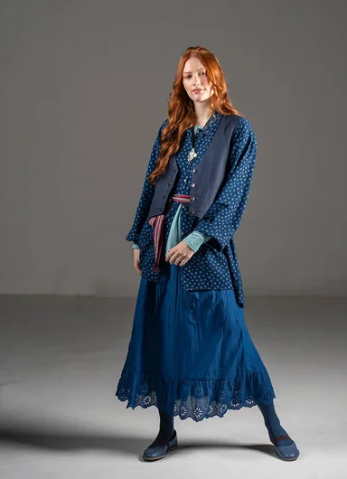 A woman wearing layers of woven clothes from Gudrun Sjödén.