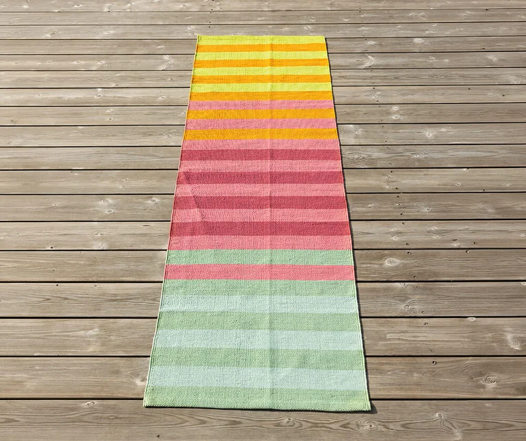 A long, narrow mat with stripes in different colours from Gudrun Sjödén.