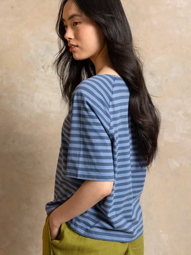 A woman wearing a red jersey dress from Gudrun Sjödén.