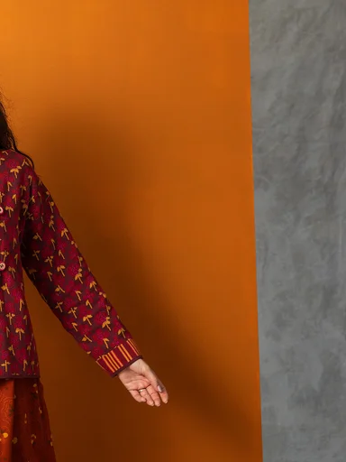 A woman wearing a floral cardigan from Gudrun Sjödén.