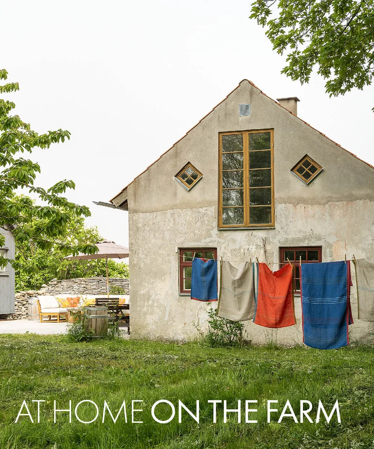 A lime-plastered house on Gotland with home textiles from Gudrun Sjödén on a clothesline.