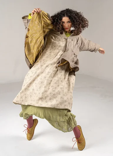 A woman wearing layers of woven clothes from Gudrun Sjödén.
