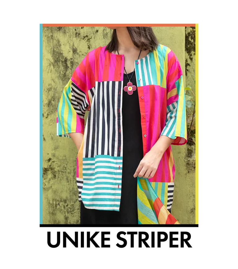 A woman wearing a colorful striped blouse from Gudrun Sjödén. 