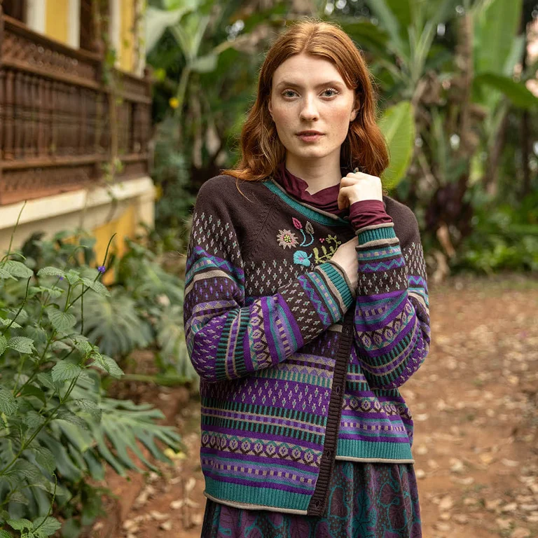 A woman wearing a patterned cardigan from Gudrun Sjödén. 