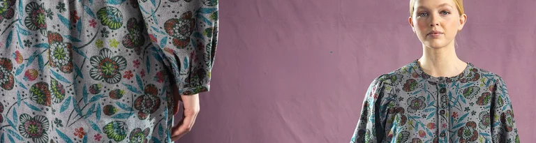 A women wearing Gudrun Sjödén clothing stand against a neutral background, with the text 'Club' on the left.