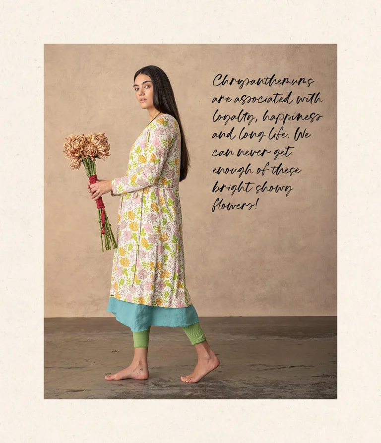 A woman wearing a floral-patterned dress from Gudrun Sjödén.