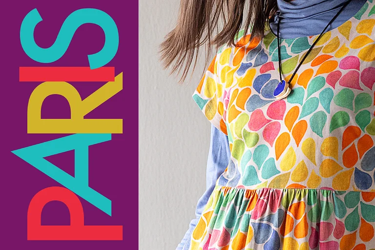 “PARIS” written in various colours on a purple background.