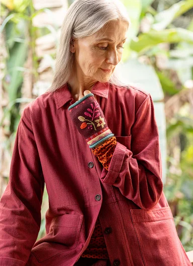A woman wearing a red shirt from Gudrun Sjödén.