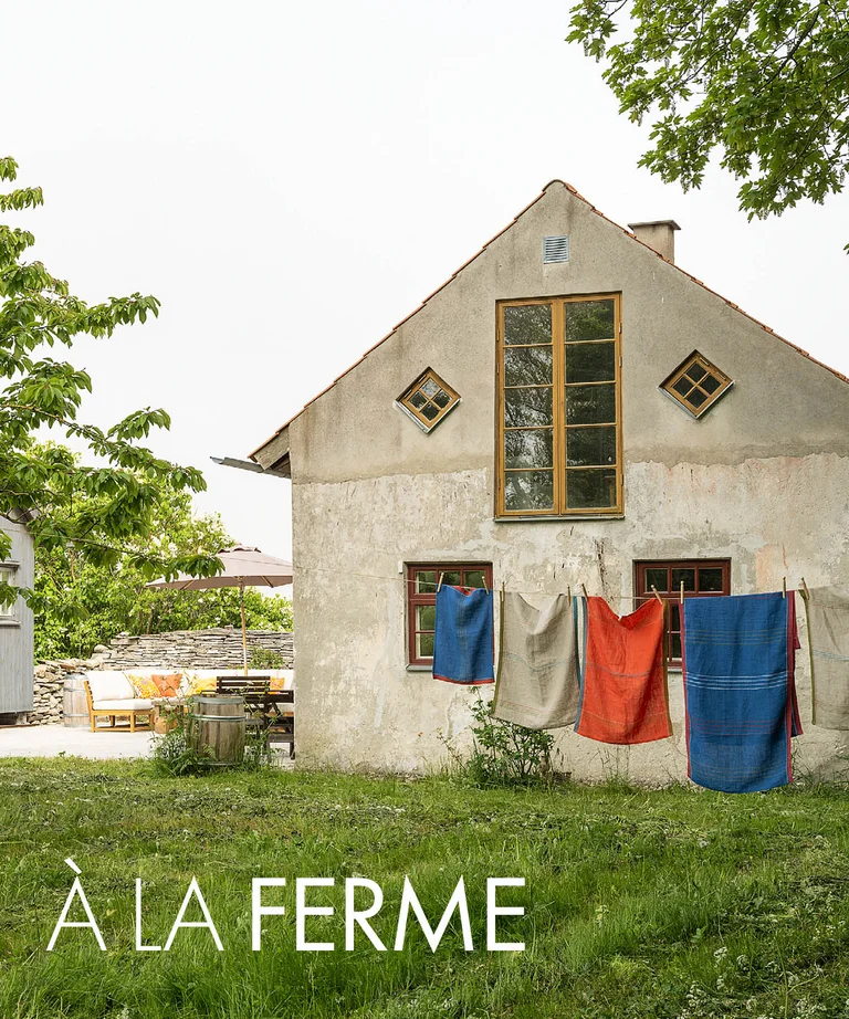 A lime-plastered house on Gotland with home textiles from Gudrun Sjödén on a clothesline.