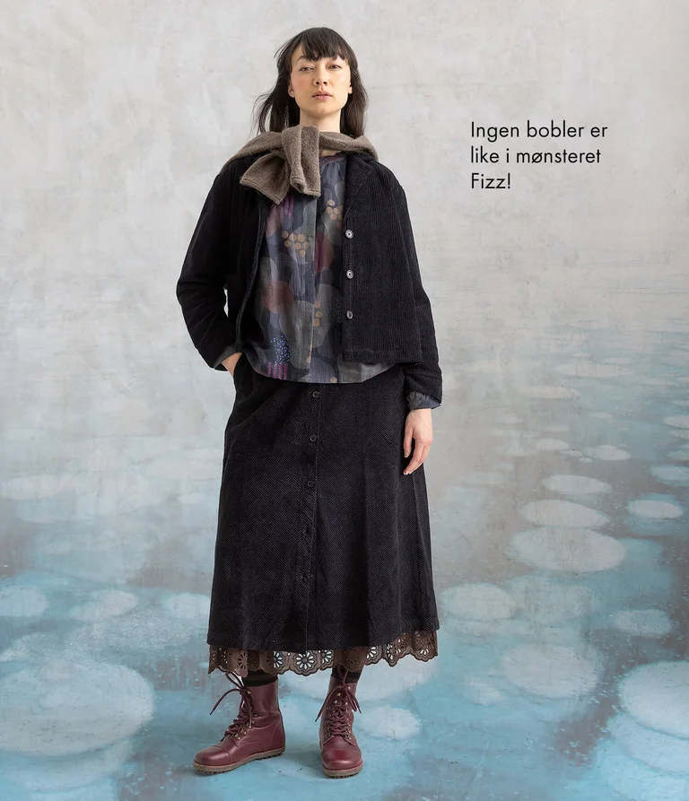 A woman wearing a jacket and skirt in corduroy from Gudrun Sjödén.