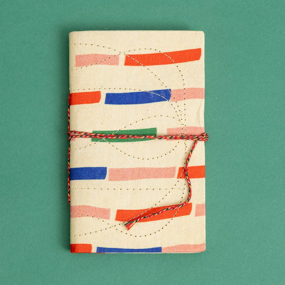Notizbuch „Divya“ aus Papier mit stoffbezogenem Einband - hellaprikose