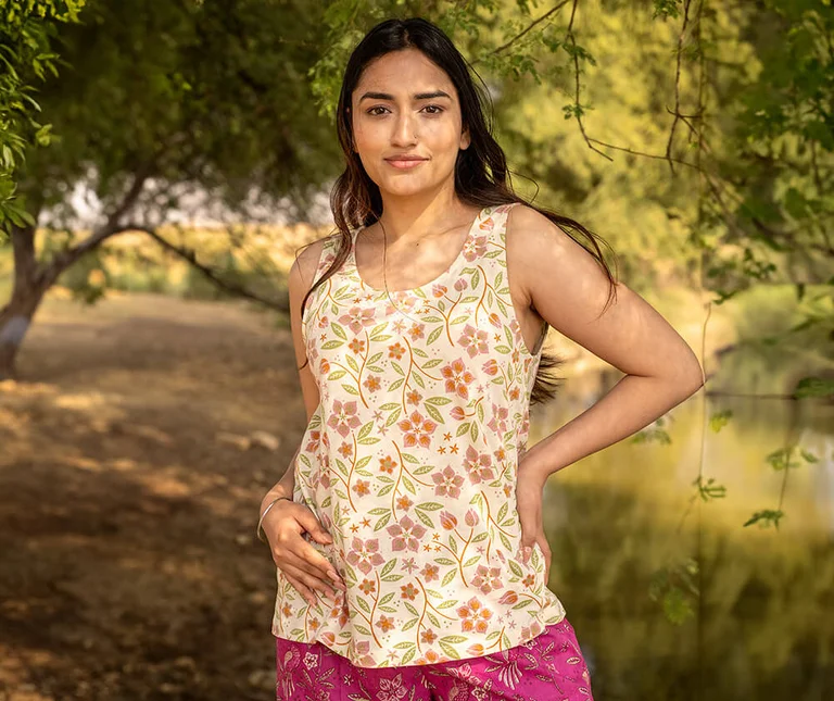 A woman wearing a floral patterned tank top from Gudrun Sjödén. 